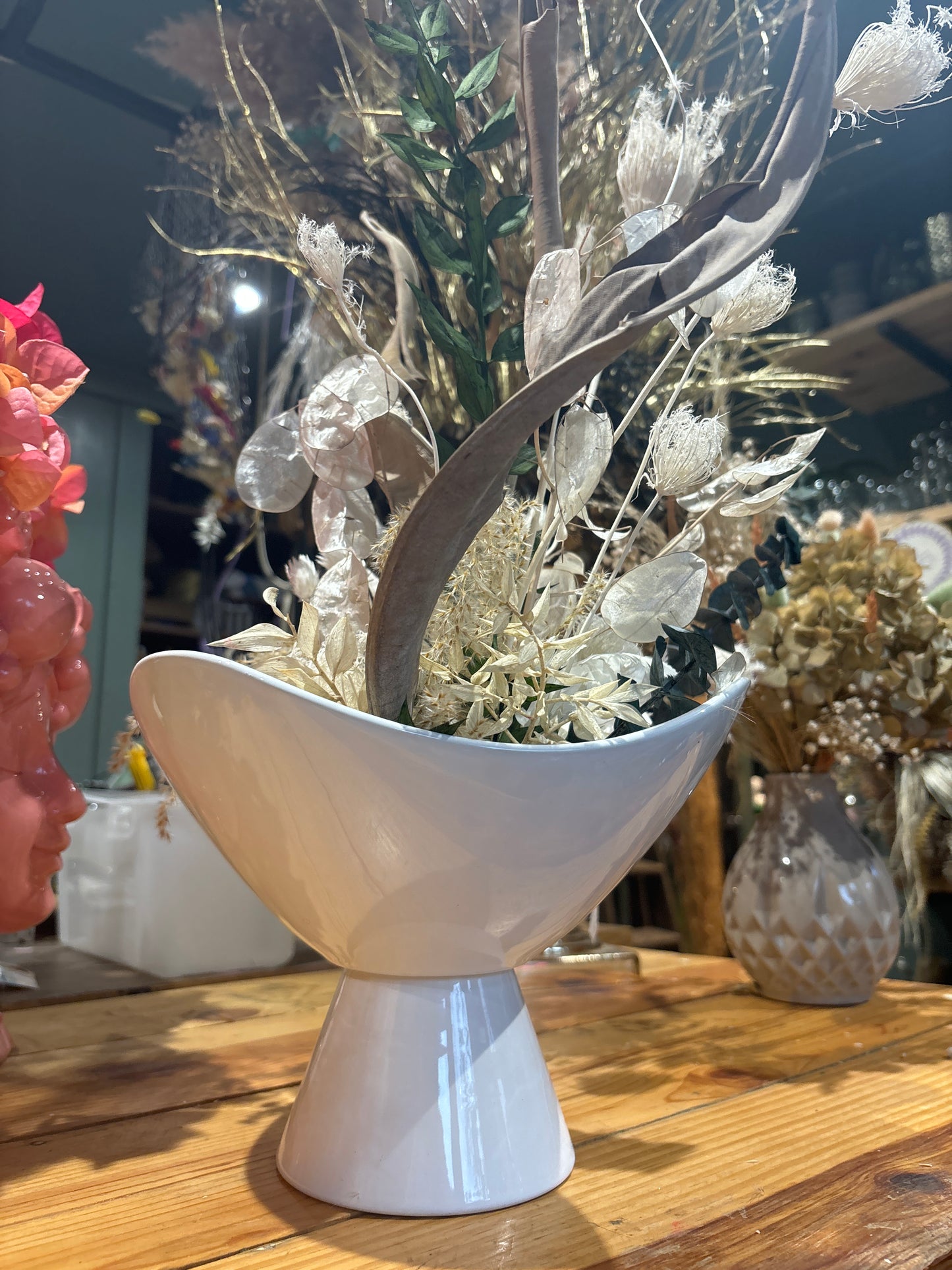 White vase with dried floral arrangement